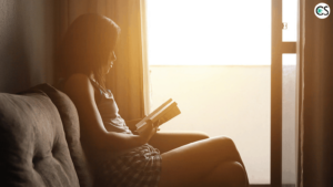girl reading at window